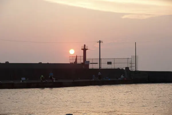 view of people on port at sunset