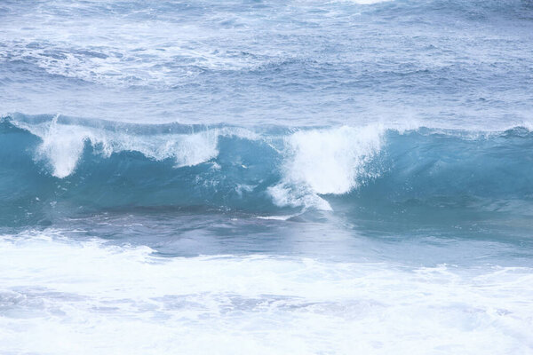 sea waves with foam crashing on beach 