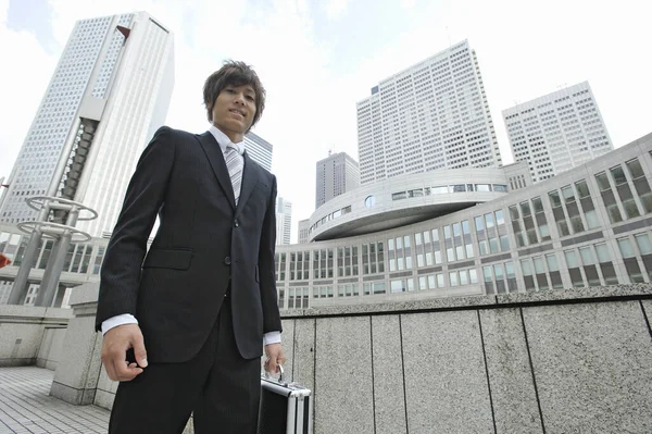 asian businessman in  suit walking in city