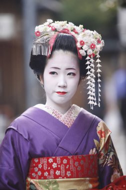 Genç Asyalı kadın geleneksel Japon kostümü ve makyajı giyiyor.