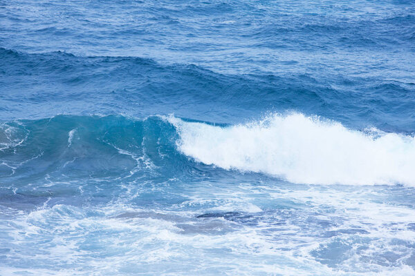sea waves with foam crashing on beach 