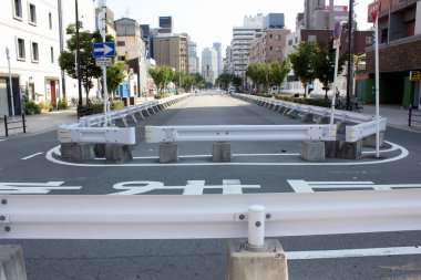 Gündüz vakti metal bariyerlerle kapatılmış boş kentsel cadde