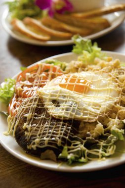 Izgara hamburger köftesi, üstüne de kızarmış yumurta.