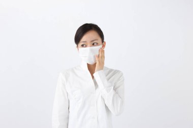 Yüz maskesi takan Asyalı kadın beyaz arka planda izole edilmiş. 