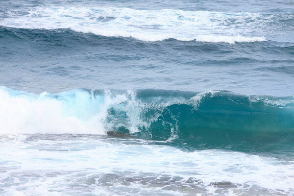 sea waves with foam crashing on beach 
