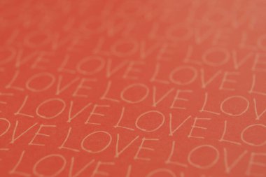 Kırmızı kağıt arka planda tekrarlanan aşk harfi deseni