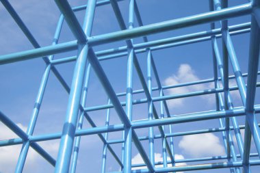 Parlak gökyüzü arkaplanı ile kesişen mavi metal çerçeve