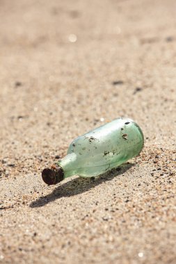 Kumsalda kumsalı olan şişe.