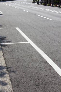 Siyah asfalt yolda beyaz park işaretleri 