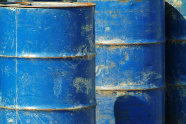 Eski paslı mavi metal variller.