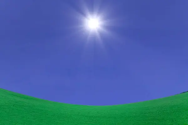 green grass with blue sky and sun