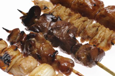 grilled meat and vegetables on a white background