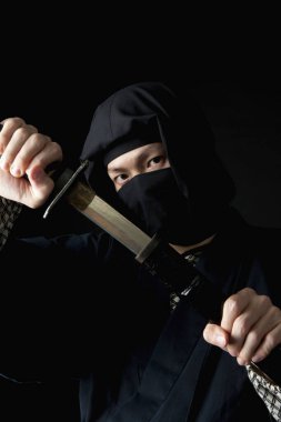 Sırtında katana olan geleneksel giysili genç Asyalı adam. 