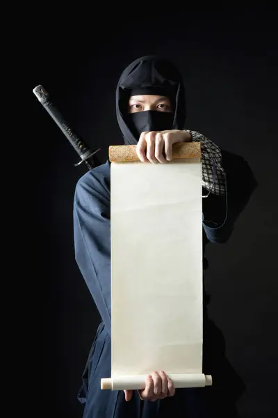 Young Man Ninja Costume Holding Rolled Paper — Stock Photo, Image