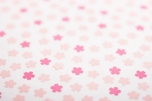 closeup of pink paper flowers on white background