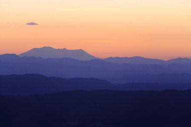 Doğanın arka planında, dağların üzerinde güzel bir gün batımı