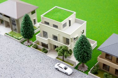 miniature houses models with green trees and lawn. real estate concept        
