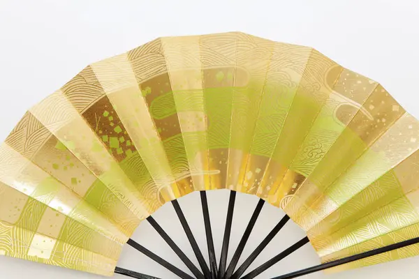 close-up view of traditional japanese folding paper fan on white background