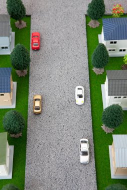 miniature houses models, green trees and parked cars                            