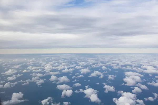 aerial view of white clouds over blue sky.