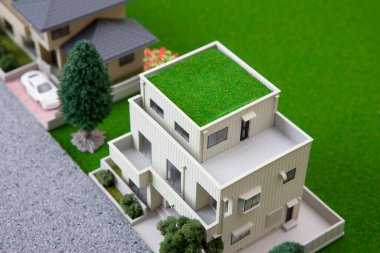 miniature houses models with green trees and lawn. real estate concept        