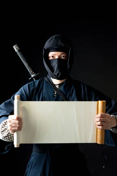 Man Ninja Mask Holding Large Piece Paper — Stock Photo, Image