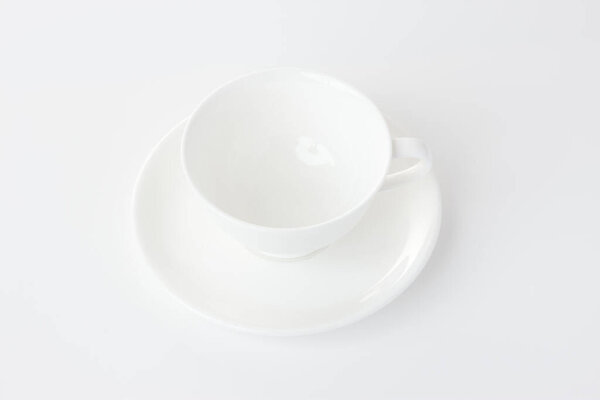white cup on a saucer