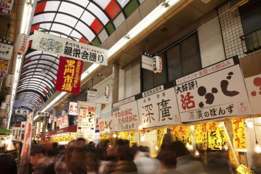  Meşgul, kapalı Japon alışveriş caddesi veya pazar atari salonu (Shtengai) parlak tabelalar ve yürüyen insan kalabalığı.