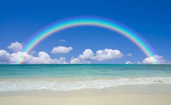 Rainbow over sea and blue sky