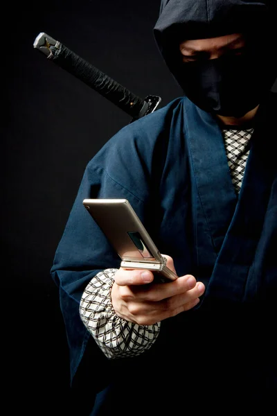 Young Man Ninja Outfit Holding Cell Phone — Stock Photo, Image