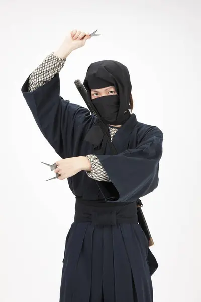 Ninja Kıyafetli Genç Adam Elinde Bir Çift Yıldız Tutuyor — Stok fotoğraf