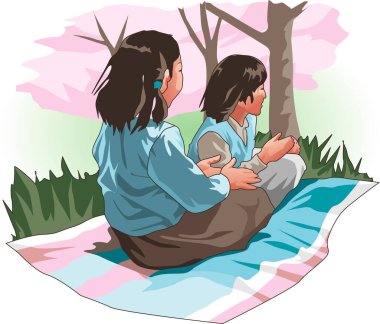 Parktaki çimlerde oturan iki çocuk.