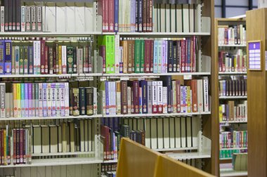 Üniversite kütüphanesinin içi kitaplık ve diğer mobilyalarla dolu