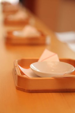 Arranging empty bowls on wooden table