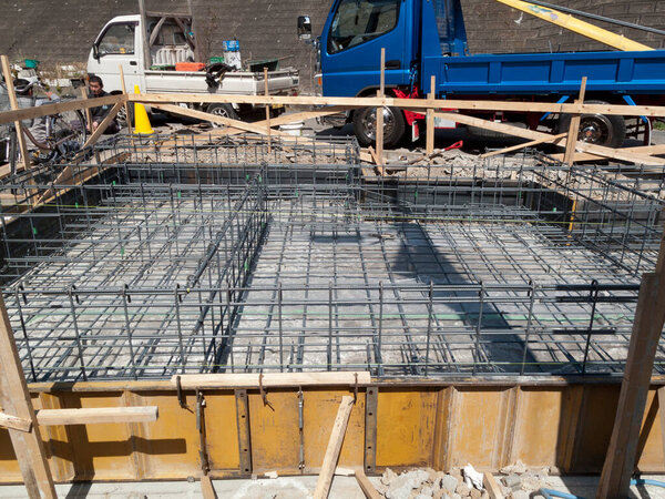 Steel reinforcement bars forming grid at construction site