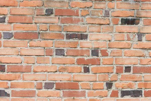 a brick wall with a fire hydrant in front of it
