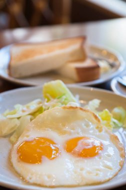 Kızarmış yumurta ve marul salatalı tost.
