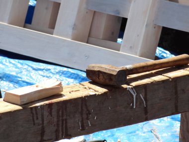 Tahta tokmak dışarıda tezgahta kesilen kerestelerin yanında dinleniyor.