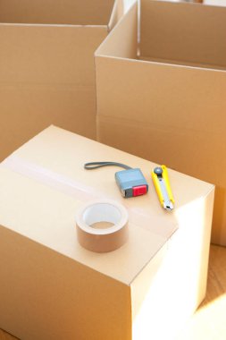 Boş odadaki karton kutudaki araçların yakın görüntüsü. yeni ev kavramı        