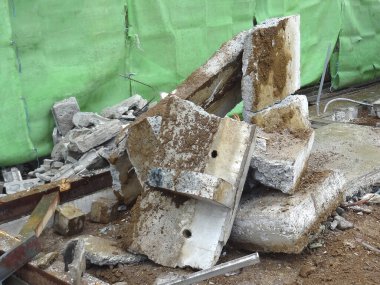 İnşaat sahasına dağılmış kırık beton levhalar.