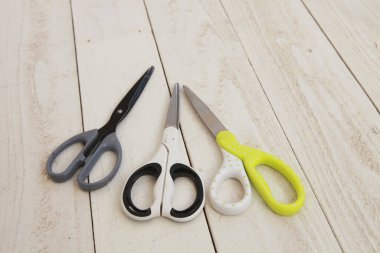 Tahta masanın üzerinde farklı bir makas seti.           