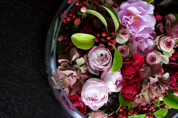 beautiful flowers in a bowl with a bouquet
