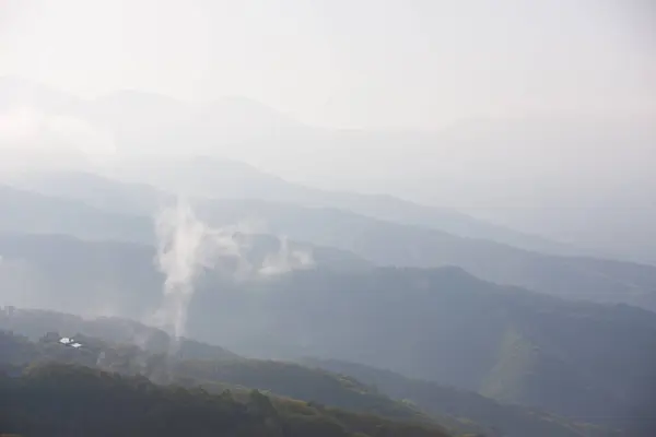 view of the mountains in fog