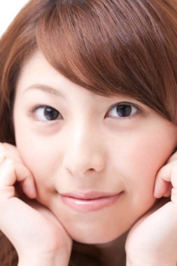 Genç ve güzel Japon kadın gülümsüyor.