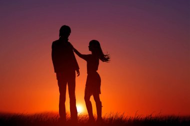 silhouette of couple on sunset