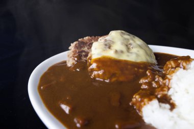 Köri soslu, pirzola ve haşlanmış pirinçli bir mutfak fotoğrafı. 