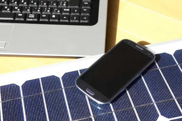 smartphone, laptop with solar energy panels