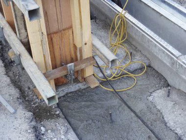 Ahşap döşeme ve sarı kablo etrafına taze beton döşeme