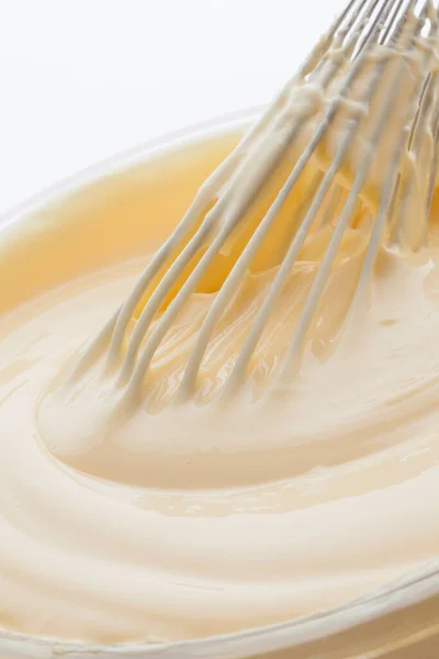 close-up shot of whisk in cream for pastry preparation