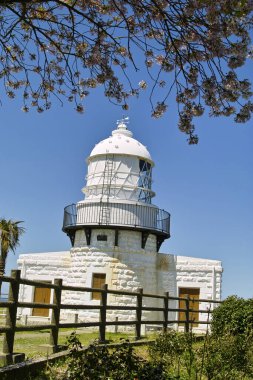 a beautiful view of a small lighthouse on a sunny day 
